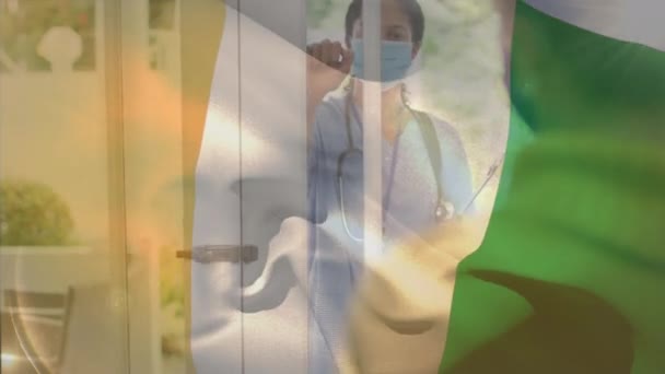 自宅でドアをノックする女性医師に対して象牙の海岸フラグを振ってのデジタル組成物 コロナウイルスCovid 19パンデミックの概念 — ストック動画