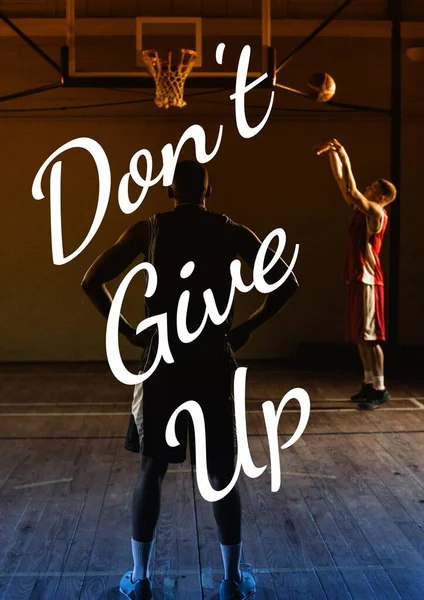 Don\'t give up text over two men playing basketball. sport, motivation, support and inspiration concept digitally generated image.