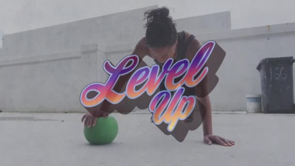 Animation Level Text Mixed Race Woman Doing Push Ups Ball — Stock Video