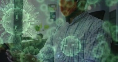 Yüz maskesi takmış bir adamın ofiste hapşırması üzerine kovid 19 hücrenin animasyonu. küresel covid 19 salgın, sağlık ve tıp konsepti dijital olarak üretilen video.