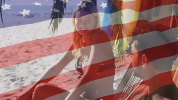 Animacja Amerykańskiej Flagi Machającej Nad Parą Leżakach Śmiejących Się Plaży — Wideo stockowe