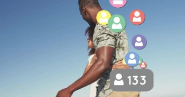 Animation of social media people digital icons over couple on beach. digital interface, social media and global networking concept digitally generated video.