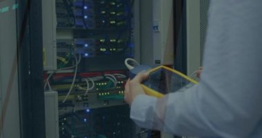 Animation of data processing on computer screens over man checking computer server. digital interface, global technology and connection concept digitally generated video.