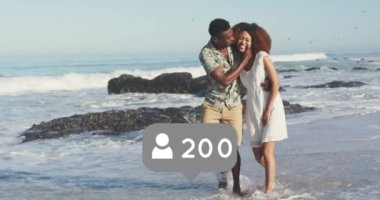 Profile icons with increasing numbers against african american couple walking on the beach. social media networking and vacation concept