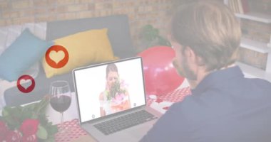 Laptop 'ta video görüşmesi yaparken beyaz adamın üzerinde birden fazla kırmızı kalp simgesi sallanıyor. Sevgililer Günü 'nün uzak kutlaması online ve flört konsepti