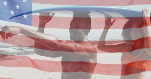 American Flag Waving African American Couple Carrying Surfboard Beach American — Stock Video