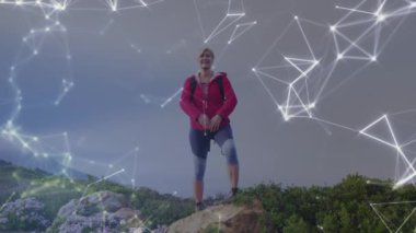 Kırsal kesimde yürüyüş yapan yaşlı beyaz bir kadınla ilgili bağlantı ağlarının animasyonu. küresel bağlantılar, aktif emeklilik yaşam tarzı konsepti dijital olarak oluşturulmuş video.