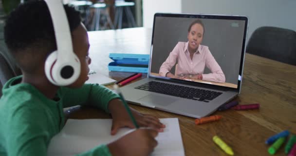 Kulaklık Takan Afrikalı Amerikalı Çocuk Ödevlerini Yaparken Bilgisayarında Video Görüşmesi — Stok video