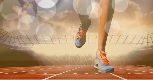 Composition of legs of running athlete on racing track with spots of light. sport and competition concept digitally generated image.