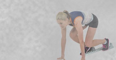 Başlangıç bloklarında ve kopyalama alanında beyaz kadın koşucunun kompozisyonu. spor ve spor konsepti dijital olarak oluşturulmuş görüntü.