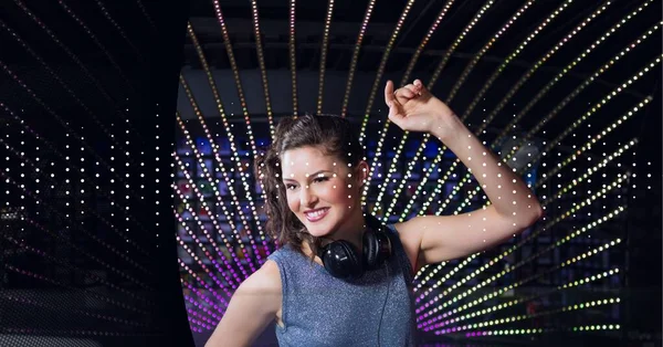 Composition of dot sound frequency level meter over smiling female dj and colourful dot stripes. audio sound visualisation concept digitally generated image.