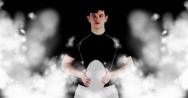 Beyaz bulanıklı siyah arka planda topu tutan beyaz rugby oyuncusunun gübresi. şampiyonluklar, spor ve yarışma konsepti dijital olarak oluşturulmuş imaj.