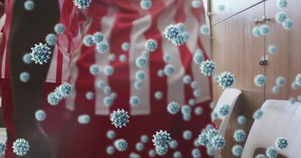 Animation Von Covid Zellen Über Fußballern Umkleidekabinen Globale Coronavirus Pandemie — Stockvideo