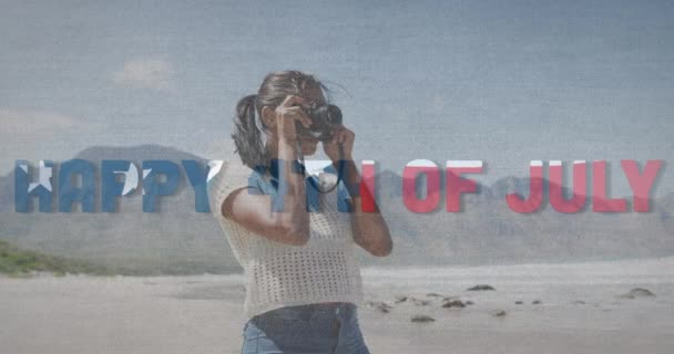 Animacja Dnia Niezależności Tekstu Nad Afrykańską Amerykanką Robiącą Zdjęcia Plaży — Wideo stockowe