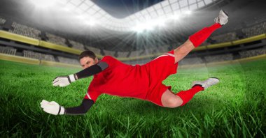 Stadyumda top yakalayan erkek kalecinin kompozisyonu. spor ve yarışma konsepti dijital olarak oluşturulmuş görüntü.