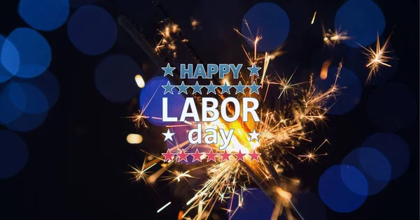 Composition of text happy labor day, with american flags and sparklers on dark blue with bokeh. patriotism, independence and labor day celebration concept digitally generated image.