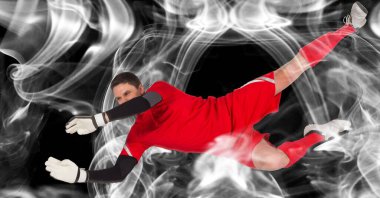 Siyah arka planda topu yakalayan erkek kalecinin kompozisyonu. spor ve yarışma konsepti dijital olarak oluşturulmuş görüntü.