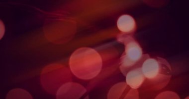 Animation of bokeh string lights, on soft focus red background. celebration, light and decor concept, digitally generated video.