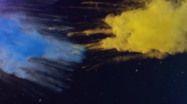 Siyah zemin üzerinde sarı ve mavi renkli toz bulunan konfeti düşüşünün animasyonu. Kutlama, olay ve gelenek kavramı, dijital olarak oluşturulmuş video.