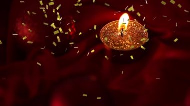 Altın konfetilerin koyu arkaplanda yanan çay ışığı mumunun üzerine düşmesi. kutlama, olay ve gelenek konsepti dijital olarak oluşturulmuş video.