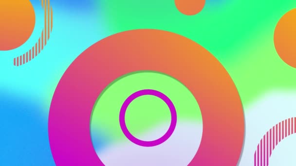 オレンジ色とピンクの円とリングのアニメーションは ぼやけた青と緑の形に移動します 色や動きの背景の概念やデジタルで生成された — ストック動画
