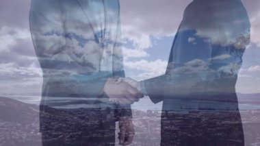 İş adamlarının manzara üzerinde el sıkışmalarının animasyonu. küresel iş, anlaşma, dijital arayüz, teknoloji ve ağ konsepti dijital olarak oluşturulmuş video.