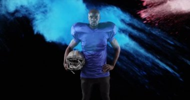 Amerikan futbolcusu üzerine renkli tozların animasyonu. küresel spor ve yarışma konsepti dijital olarak oluşturulmuş video.