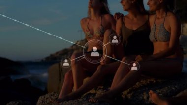 Sahilde kucaklaşan kadın arkadaşlarla olan bağlantıların animasyonu. küresel bağlantılar, fitness ve refah konsepti dijital olarak oluşturulmuş video.