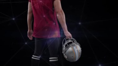Siyah arka planda Amerikan futbolcusu üzerinden bağlantı ağının animasyonu. global spor, rekabet ve bağlantılar dijital olarak oluşturulmuş video konsepti.