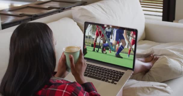 Sammansatt Kvinna Sitter Hemma Håller Kaffe Tittar Hockey Match Laptop — Stockvideo