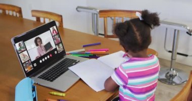 Evde online ders için dizüstü bilgisayar kullanan liseli kız, ekranda çeşitli öğretmenler ve sınıflar var. iletişim teknolojisi ve çevrimiçi ilköğretim konsepti, dijital kompozit video.