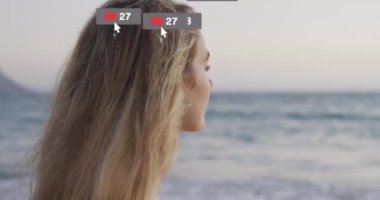 Kafkasyalı bir kadının deniz kenarında manzaraya hayran olması üzerine afişlerde sosyal medya simgelerinin canlandırılması. Sosyal medya, dijital arayüz ve bağlantılar konsepti dijital olarak oluşturulmuş video.