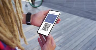 Rastalı adam elinde akıllı telefon, inandırıcı aşı sertifikası, eu bayrağı ve ekranda QR kodu tutuyor. covid 19 konseptinde dijital olarak üretilen sağlık, yaşam tarzı, seyahat ve teknoloji.