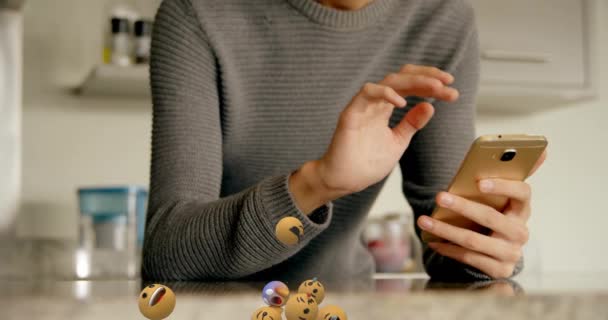 Multiple Face Emojis Floating Man Smiling While Using Smartphone Home — Stock Video