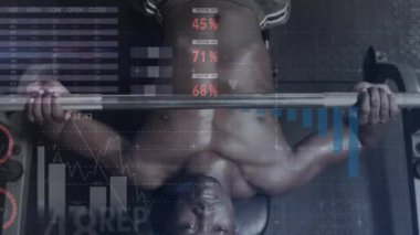 Spor salonunda bench press egzersizi yapan Afrikalı Amerikalı adama karşı istatistiksel veri işleme. spor ve spor konsepti