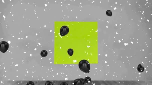 灰色の背景に緑色のメモノートに浮かぶコンフェッティ落下と複数の黒い気球 イベントの装飾とパーティーのお祝いのコンセプト — ストック動画
