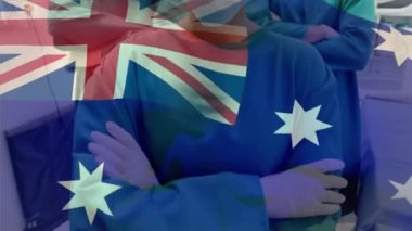 Avustralya bayrağı hastanede yüz maskesi takan cerrah takımının portresine karşı dalgalanıyor. Sağlık ve Tıp Konsepti.