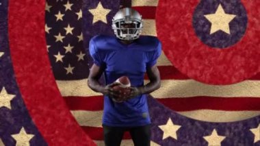 Amerikan futbolcusunun Amerikan bayrak deseni ve renk çemberleri üzerindeki animasyonu. spor, rekabet ve vatanseverlik kavramı dijital olarak oluşturulmuş video.