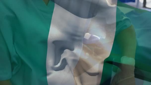 Nigeria Flag Waving Caucasian Female Health Worker Wearing Face Mask — ストック動画