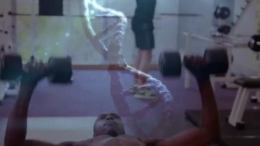 Güçlü bir adamın egzersiz yapması üzerine DNA iplikçiklerinin dönüşünün ve veri işlemesinin animasyonu. global spor, fitness, sağlıklı yaşam tarzı ve dijital olarak üretilen veri işleme konsepti.