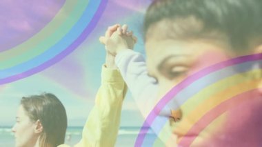 Çiçek gücü metninin gökkuşağı ve çiçeklerle el ele tutuşan iki kadının animasyonu. İnsan hakları ve eşitlik kavramı dijital olarak oluşturulmuş video.