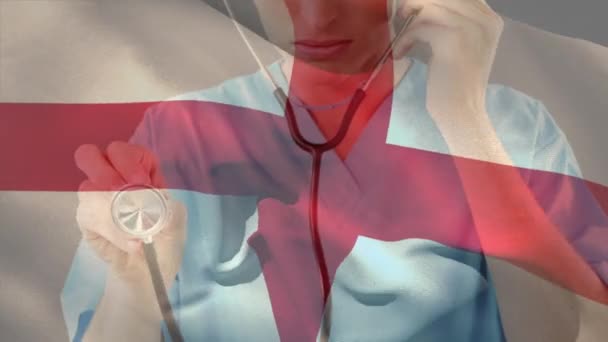 Цифровой Состав Английского Флага Размахивающего Над Кавказской Женщиной Медиком Держащей — стоковое видео