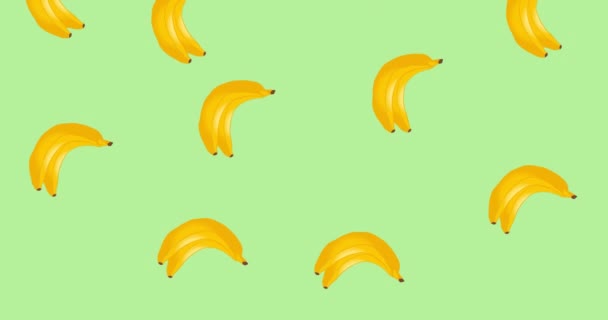 Animation of single bananas floating on green background. tropical fruit, wellbeing, summer and holiday concept digitally generated video.
