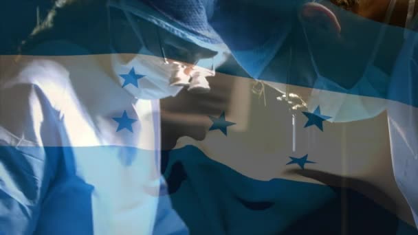 Waving Honduras Flag Surgeons Wearing Magnifying Glasses While Performing Surgery — Stock Video