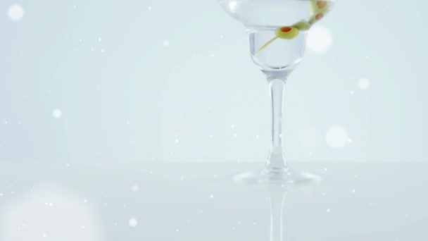 Witte Vlekken Zwevend Olijven Die Tegen Een Grijze Achtergrond Cocktailglas — Stockvideo