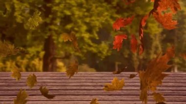 Ormana karşı ahşap yüzeyde yüzen çoklu sonbahar yapraklarının dijital animasyonu. Sonbahar mevsimi konsepti