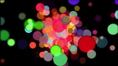 Siyah arkaplanda yüzen renkli ışık çemberlerinin canlandırması, ekranı doldurur. 