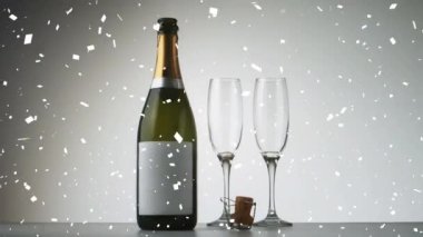 Şişenin üzerine konfeti düşmesi ve şampanya kadehlerinin canlandırılması. Yeni yıl partisi ve dijital olarak üretilen video konsepti.