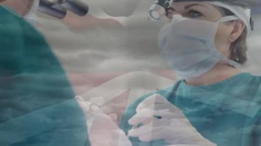 Ameliyat sırasında doktorların üzerinde İngiliz bayrağının canlandırılması. küresel tıp, sağlık ve teknoloji konsepti dijital olarak üretilen video.