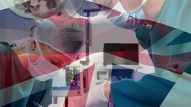 Ameliyat sırasında doktorların üzerinde İngiliz bayrağının canlandırılması. küresel tıp, sağlık ve teknoloji konsepti dijital olarak üretilen video.